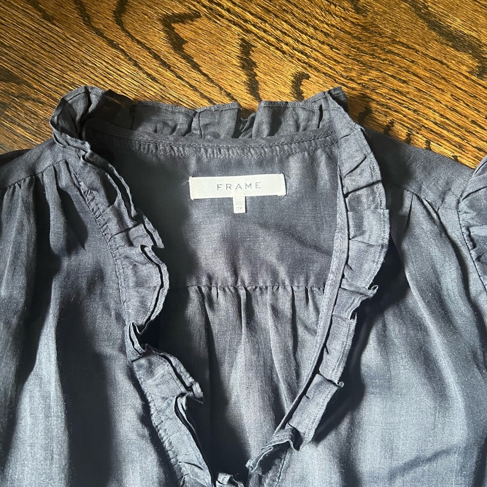Short sleeve linen navy top with ruffle detail by Frame Denim. Size xs